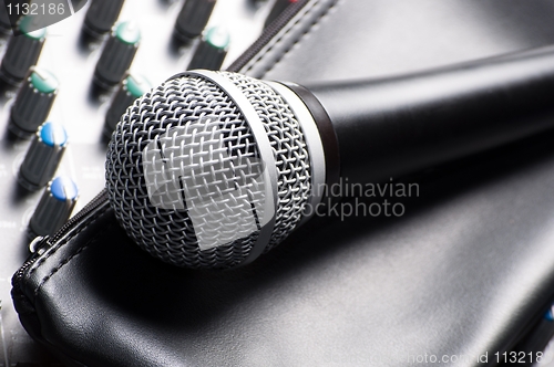 Image of Part of an audio sound mixer with a microphone and its sleeve