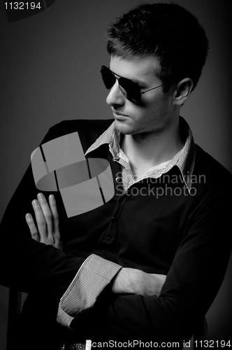 Image of Portrait of a young man wearing sunglasses in black and white