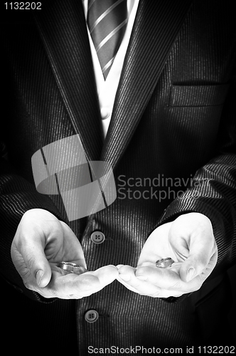 Image of Closeup of a man holding engagement rings