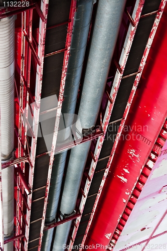 Image of angle shot of pipes going between metal plates