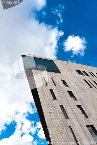 Image of Modern building angle shot against blue sky