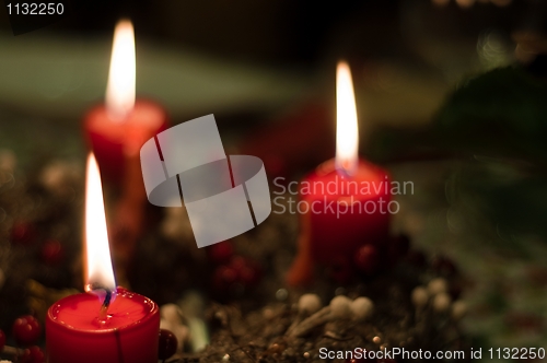 Image of Christmas candles on girlde with blurry background