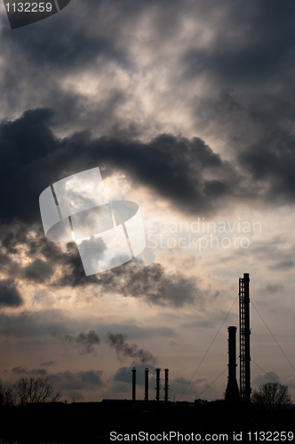 Image of silouette of a powerplant with smoke coming out of chinney