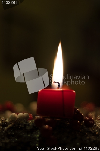 Image of Christmas candle on girlde with blurry background