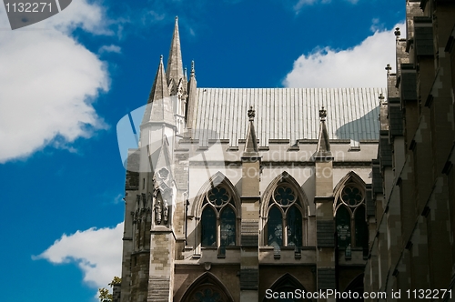 Image of Refurbished temple in sunlight against blue sky