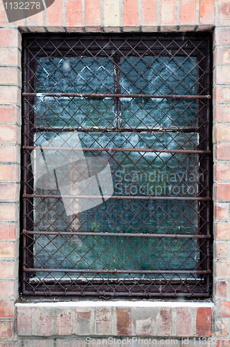 Image of Old window closeup with bars on it