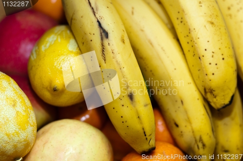 Image of fresh fruits closeup with banana lime orange and apple