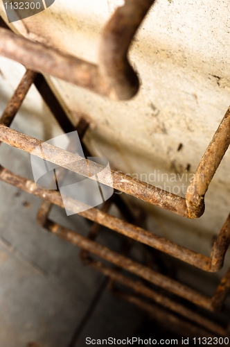 Image of Rusty ladder leading into hole