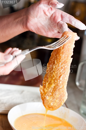 Image of Fresh meat with yolk focus on hands with blurry background