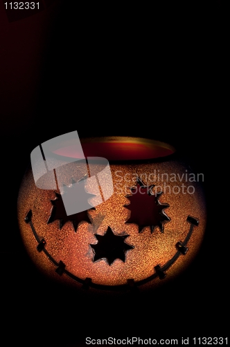 Image of Pumkin shaped candle holder against dark background
