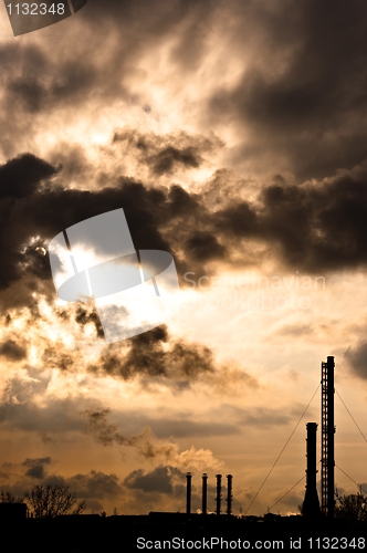 Image of Silhouette of a power plant against evening sky