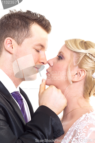 Image of A couple on their wedding day kissing and laughing