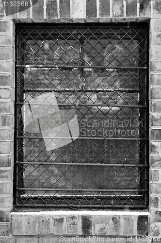 Image of Old window closeup with bars on it  in black and white