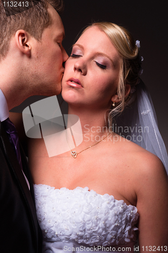 Image of Groom kissing the bride