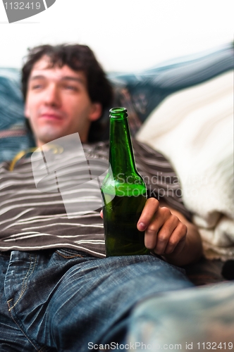 Image of Young man with beer in his hands