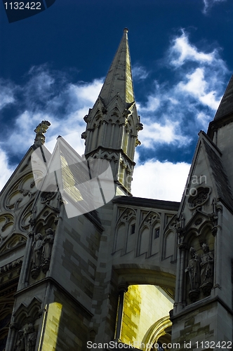 Image of Refurbished temple in sunlight against blue sky