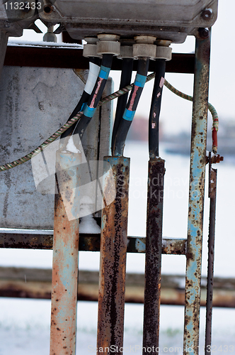 Image of Old rusty electricity box and cables