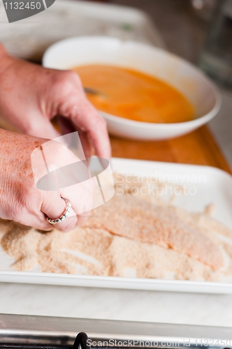 Image of Fresh meat with crumb with the hands of the cook