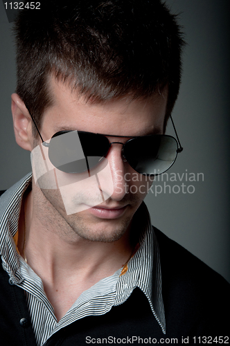 Image of Portrait of a young man wearing sunglasses