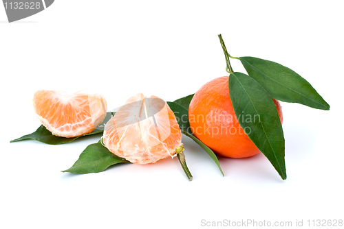 Image of Whole and peeled mandarines and some mandarin leaves