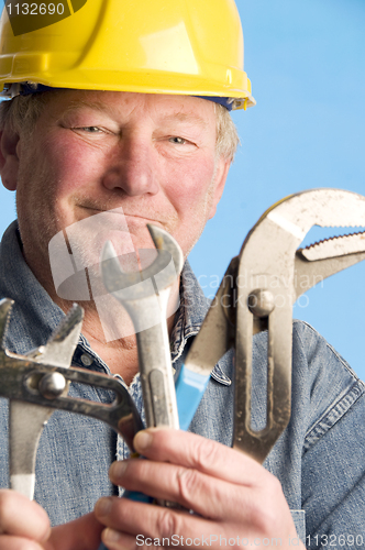 Image of smiling happy contractor builder with tools