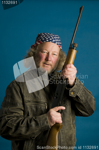 Image of handsome middle age man flag bandana leather jacket firearm weap