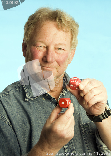 Image of handsome middle age man holding dice