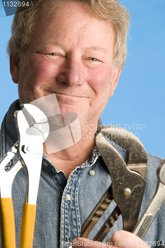 Image of smiling happy contractor builder homeowner with tools