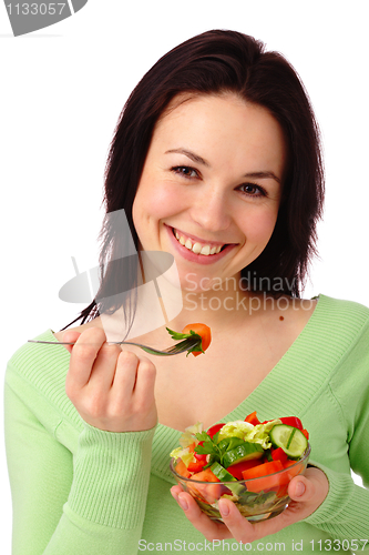 Image of Young attractive woman eats vegetable salad