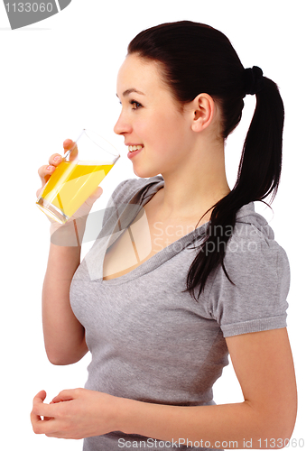 Image of Young attractive woman drinks orange juice
