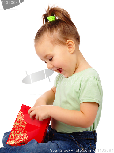 Image of Cute little girl with red shopping bag