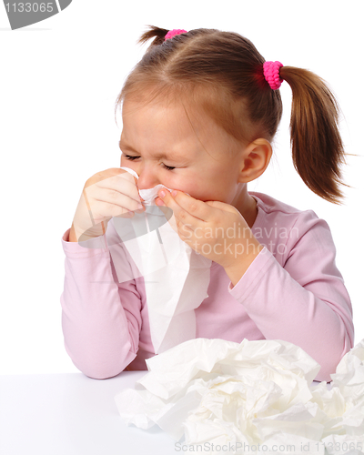 Image of Little girl blows her nose