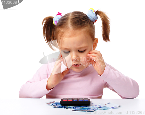 Image of Little girl with few paper euro banknotes