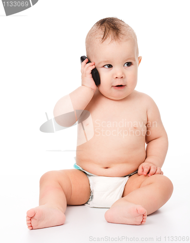 Image of Cute little baby is talking on cell phone
