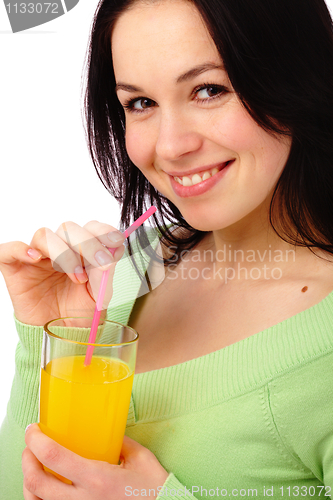 Image of Young attractive woman drinks orange juice