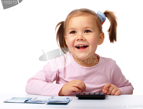 Image of Little girl with few paper euro banknotes