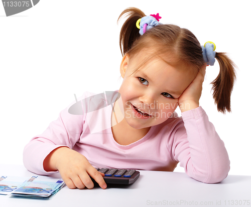 Image of Little girl with few paper euro banknotes