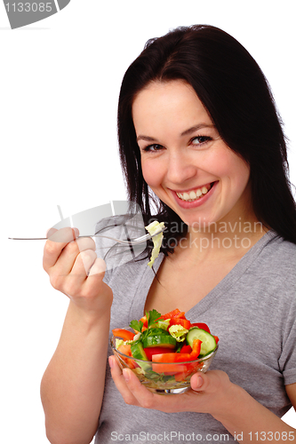 Image of Young attractive woman eats vegetable salad