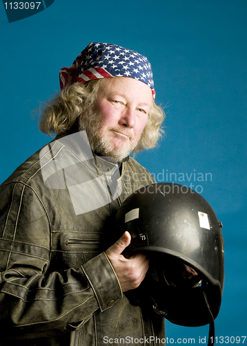 Image of motorcycle rider with helmet American flag bandana