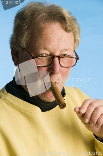 Image of handsome cigar smoking middle age senior man worn turtleneck shi