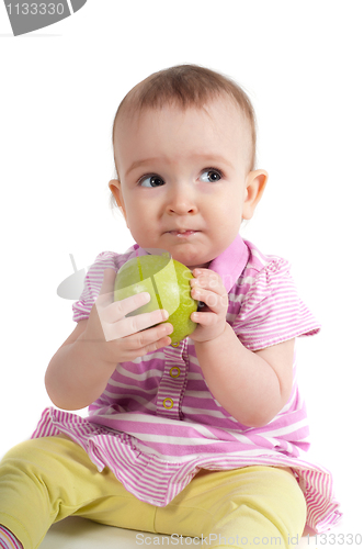Image of Baby girl in pink eating apple