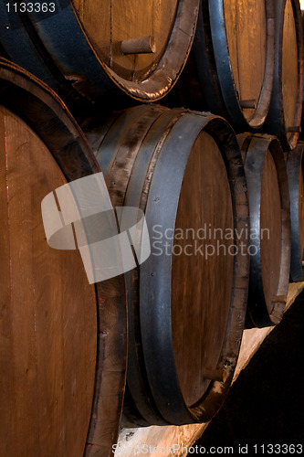 Image of stacked wine barrels in the wine cellar 