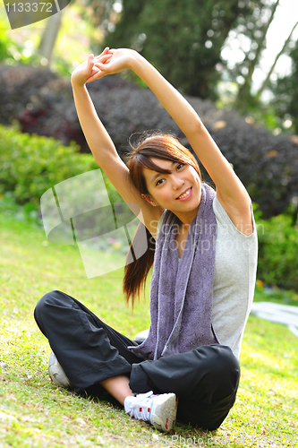 Image of woman doing stretching exercise in park