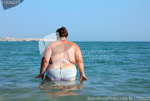 Image of overweight woman bath in sea