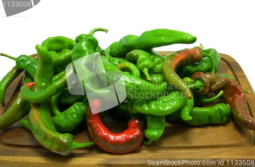 Image of Hot peppers on wooden kitchen board