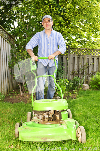 Image of Man mowing lawn