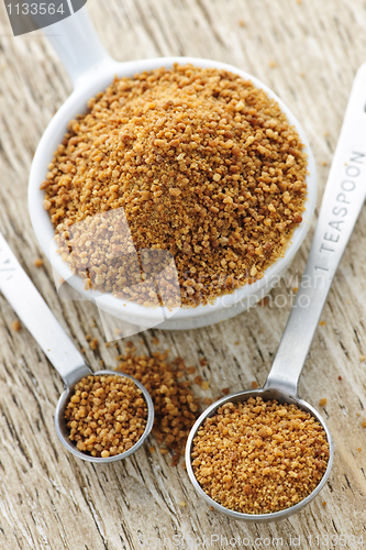 Image of Coconut palm sugar in measuring spoons