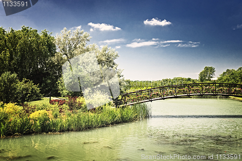 Image of Pond with foot bridge