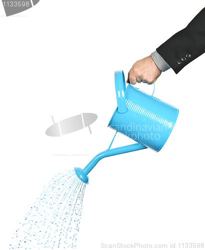Image of Hand pouring water from watering can