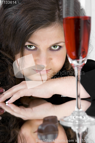 Image of The beautiful young woman with wine glass